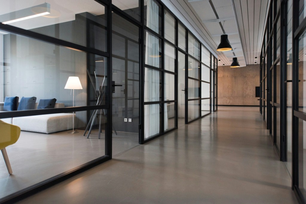 Modern corporate office corridor with glass partitions
