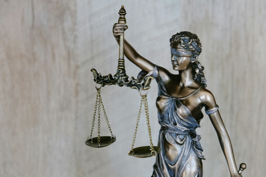 Bronze Lady Justice statue holding scales