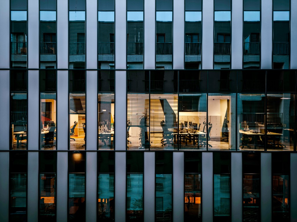 Office building facade with illuminated windows at dusk